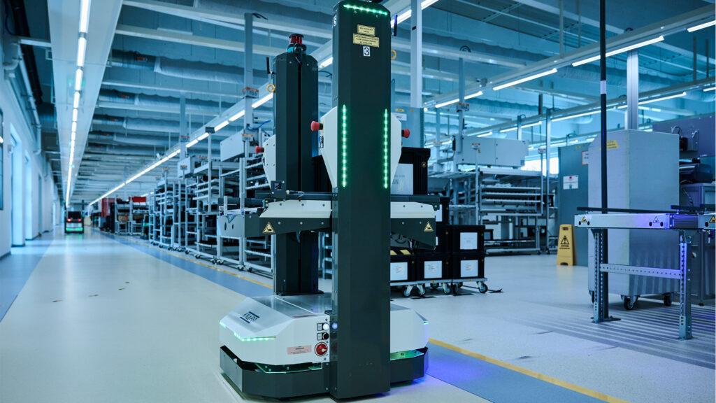 Autonomous mobile robot operating in a modern industrial facility.